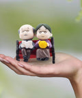 Mini Park Bench Grandpa And Grandma Figurines For Bonsai Garden And Fairy Garden Decor. Tiny plastic ornaments held in hand.