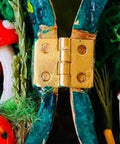 Close-up of a single brass butt hinge installed on a colorful decorative item, part of the Ten Pack 1 Inch Brass Butt Hinges With Screws For Cabinets Drawers And Jewelry Boxes DIY Friendly Durable Solid Brass Rust Proof Easy Install Heavy Duty Hardware Kit By Quweiz.