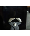 Close-up of Heavy Duty End Cutting Nipper Pliers 14 Inch gripping a nail, showcasing hardened honed cutting edges.