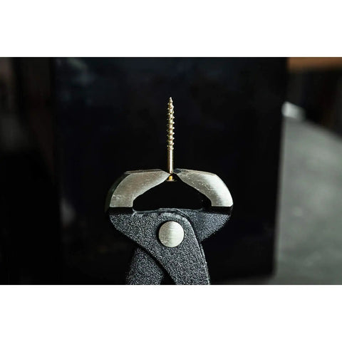 Close-up of Heavy Duty End Cutting Nipper Pliers 14 Inch gripping a nail, showcasing hardened honed cutting edges.