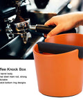 Orange ABS Coffee Knock Box 2.5L Open Top With Non Slip Base for home cafes, showing deep bowl design and easy knockout feature