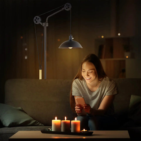 Woman reading by stepless dimmable industrial floor lamp with pulley system, rustic farmhouse tall arched standing lamp in deep bronze.