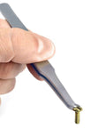 Close-up of black screw holding tweezers gripping a small brass screw, ideal for electronics repair and DIY precision tasks.