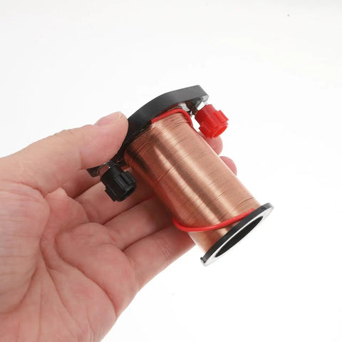 Hand holding copper coil from Hands On Electromagnetic Induction Solenoid Kit For High School Physics With Primary And Secondary Coils A Real Life Science Experiment Tool For Demonstrating Faradays Law And Electromagnetism Basics.
