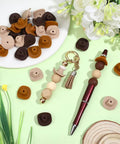 Cowboy Hat Silicone Beads Set For Jewelry Making And DIY Craft With Mini Western Cowboys 3D Charms Beadable Pens Focal Spacers Bulk Rustic Brown Beige Burnt Yellow Hues 30 Pcs on display with pen and keychain