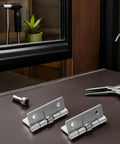 Hardcore Stainless Steel Self Closing Hinges on a table with tools, suitable for coastal climates and rust proof.