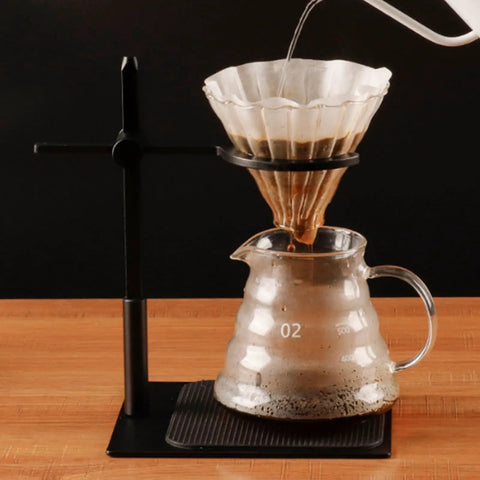 Adjustable Pour Over Coffee Stand Featuring Rock Solid Aluminum Base For Home Office Brewing with coffee dripping into glass pitcher.