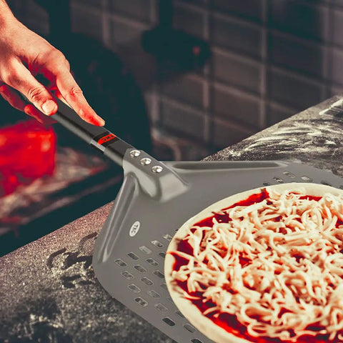 Person using Perforated 12 Inch Pizza Peel, Metal Pizza Turner For All Ovens, Indoor Outdoor Use, Lightweight And Durable Anodized Aluminum