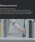 Hand using Built Tough Digital Tape Measure Packs A Massive 328 Foot Rolling Reach With A Crisp Lcd Panel for accurate measurements.