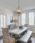 Dining room with Orb Farmhouse Chandelier 4 Light Handmade Wood Rustic Vintage Pendant For Dining Room Living Room Foyer Bedroom Kitchen Island Entryway Cozy Country Vibe 15.7 Inch Diameter hanging above a rustic table.