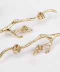 Slick Twig Drawer Pulls In Polished Brass Plum Blossom Branch Handle For Cabinets And Dressers shown on white surface