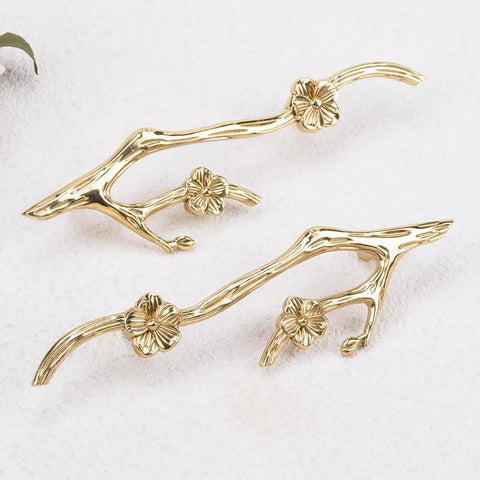 Slick Twig Drawer Pulls In Polished Brass Plum Blossom Branch Handle For Cabinets And Dressers shown on white surface