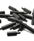 Top Tier M3 Hex Male To Female Nylon Standoffs Bulk Crate Of 50 Black Polymer Spacer Blocks scattered on white background.