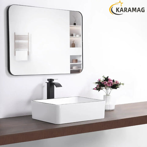 White Rectangle Vessel Sink For Bathroom Above Counter Porcelain Ceramic Basin With Black Rim Edge Modern European Inspired Design 18 Inch Exterior Sleek Small Sink Bowl For Bathrooms on wooden counter with mirror and flowers