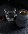 All In One Plasma Cutting Torch Consumable Kit For IPT 60 PT 60 PT40 IPT 40 Series Includes 25 Pieces Tips 0.9mm 0.035in And 1.1mm 0.045in Electrodes Shield Cap Standoff Swirl Ring And O Rings For Easy Plug In Ready To Use components on dark surface, showing metal parts and rubber sections close-up.