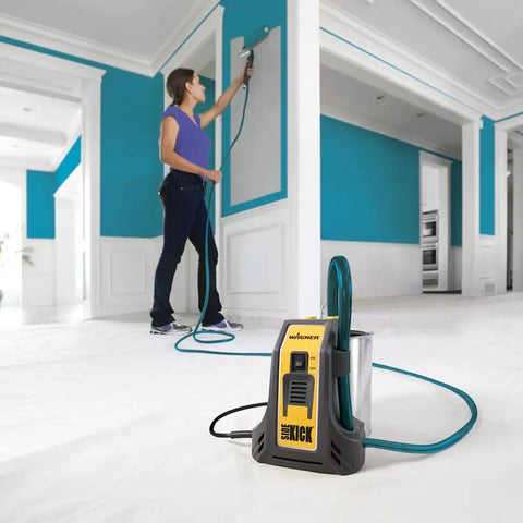 Person using Smart Sidekick Workhorse Power Paint Roller Direct Feed System in a large room for smooth coverage.