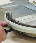 Adjusting the bevel on a 10 Inch 15 Amp Compound Miter Saw With Beefy 4600 RPM Motor, Dual Post Arm for precise cuts.