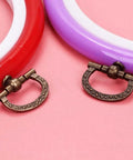 Mini Cabinet Knob Set Ten Pack Antique Bronze Finish displayed with colorful backgrounds.