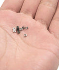681ZZ 10-Pack Mini Metal Shielded Deep Groove Ball Bearings 3×7×3 mm resting on a hand, showing size and detail.