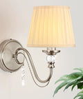 1-Light Brushed Nickel Vanity Light with Beige Fabric, Modern Wall Sconce, with crystal accents and pleated shade.
