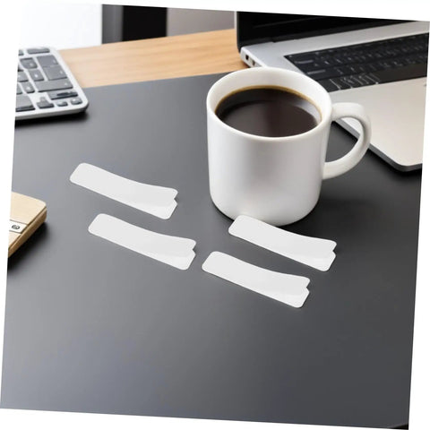 100 Pack Double Sided Hook And Loop Strips With White Pet Film Backing 2.5x10cm on a desk next to a coffee cup.