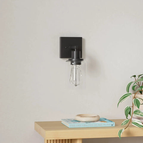 Two Pack Black Vanity Wall Sconces Modern Industrial Wall Lighting With Clear Glass Shades For Bathroom Mirror Living Room Bedroom Hardwire UL Listed Matte Black Finish featuring a single sconce on white wall.