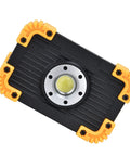 YWBL-WH Mini COB Emergency Flood Light, 6-Angle Adjustable Stand top view with yellow accents and durable black housing.