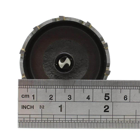 Front view of a 2-inch carbide-tipped hole saw with a steel body and center pilot bit beside a ruler for scale