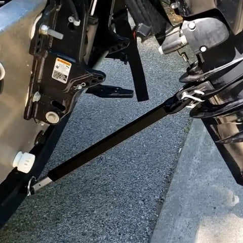Adjustable Boat Transom Saver For Outboard Motors With Composite Head Transom Support attached to motor and trailer