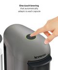 Person pressing button on Vertuo Plus Coffee And Espresso Maker By Breville Grey One Button Brew For Coffee Or Espresso No Fuss Easy Button Brew 25 Second Heat Up And Energy Saving Auto Shut Off Delivers Rich Flavor At Home