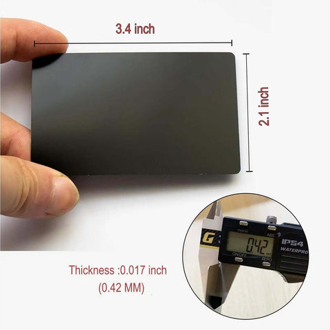 Person holding a matte black 0.42mm aluminum card, dimensions 3.4 x 2.1 inch, with a caliper showing thickness, Thick 0.42mm Aluminum Business Card Blanks For Laser Engraving, 50 Pcs Matte Black Pro Grade Metal Cards For DIY Gifts, Multipurpose Craft Supplies For Laser Etching And Custom Card Projects.
