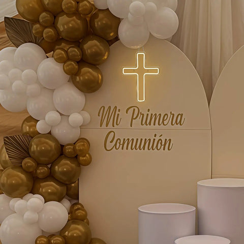 Cross LED neon sign with "Mi Primera Comunión" surrounded by gold and white balloons