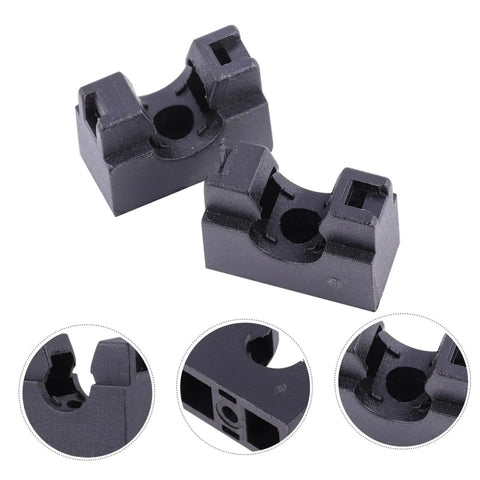 Two black plastic hose holder blocks with deep cradle holes for securing aquarium tubing.