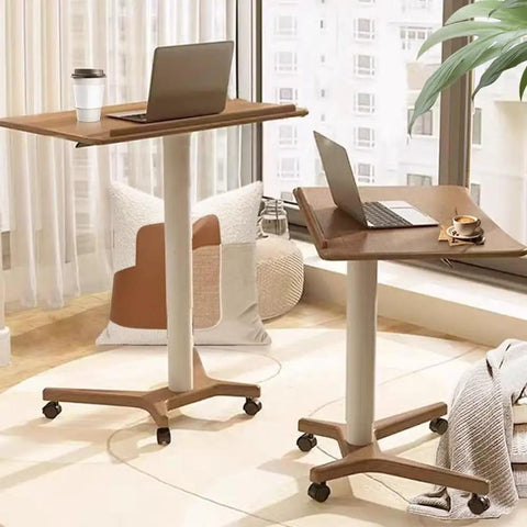 No Drama Roll Mobile Standing Desk Featuring Smooth Gas Lift Adjustments And A Tilt Tray Top Portable Laptop Desk with laptop and coffee cup.