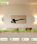 VOOOV 7.9 Inch White LED Wall Sconce Includes 5CCT Dimmable Lighting mounted on wall illuminating a modern living room.