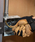 Person using Top Shelf 13 Inch Flexible Fish Tape Leader For 1/8 Inch Steel Tapes in electrical box with gloves.