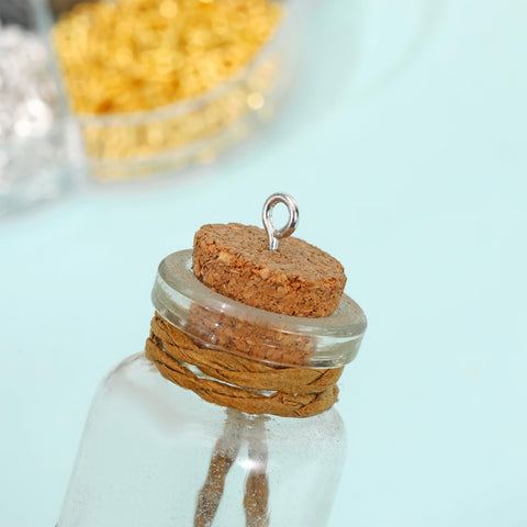 Close-up of a corked glass bottle with an eye screw inserted, showcasing the 7 Color 450 Piece Eye Screw Pins Set Eight By Four Millimeter Tiny Eyelets For Jewelry Making Bead Charms And DIY Crafts Handy Mini Eye Hook Screws For Arts Projects Ideal For Bead Charms Jewelry Making Mini Pendants And Craft Projects At Home Or Studio.