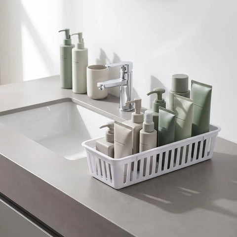 Eighteen Pack Slick Slim Plastic Baskets For Narrow Drawer Setup. Slim white basket holding various beauty products on a countertop.