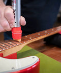 Using fretboard conditioner from Complete Guitar Care Kit And Clean Polish Set With Fretboard Conditioner on guitar neck.
