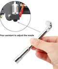 Hand holding a nozzle adjustment tool for 25Pcs MK8 Ender 3 V2 Brass Nozzles 0.4mm Set With DIY Tools Storage Box For Creality Ender 3 Series And CR 10 3D Printers Ready To Rock High Heat Abrasion Resistant