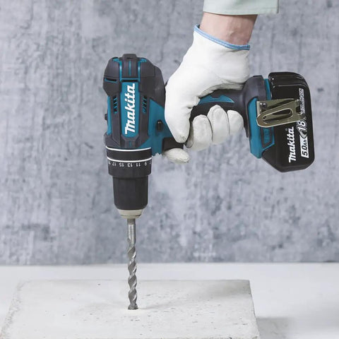 Eighteen Volt Combo Drill Featuring Rock Solid Keyless Chuck Dual Gear Motor Up To Sixty Two Newton Meters Torque in use on concrete