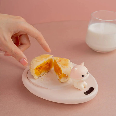 Smart Coffee Mug Warmer Set It And Forget It Design with a hand pointing at a pastry on a pink plate, featuring a cute cat figure.