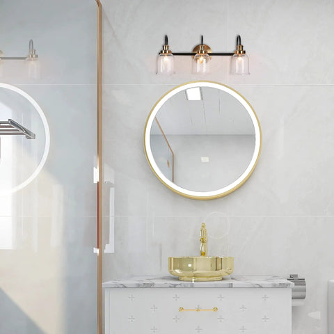 Modern 3 Light Seeded Glass Vanity Light Fixture in matte black and brushed brass finish with circular backplate above bathroom sink