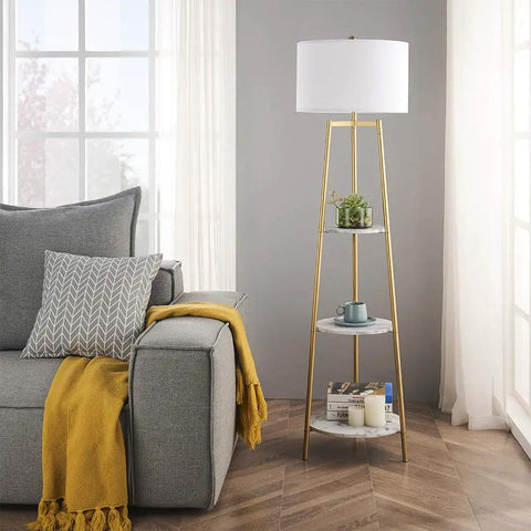 Dope Modern Floor Lamp With Faux Marble Shelves And Fabric Shade next to gray couch in living room, showcasing tall sleek design.