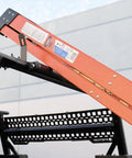 Built Tough 23.5 Inch Powder Coated Aluminum Ladder Roller With T Slot Compatibility For Roof Racks And Pickup Trucks providing stability for loading a ladder.