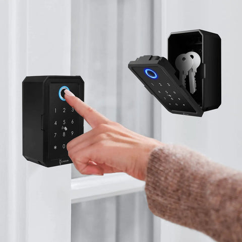 Person using Matrix Key Lock Box with wireless hub and Bluetooth access, showing keypad and open compartment with keys for outdoor use.