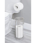 Freestanding Toilet Paper Holder No Drill Install Holds 3 Spare Rolls Matte Silver Bathroom Dispenser beside toilet.