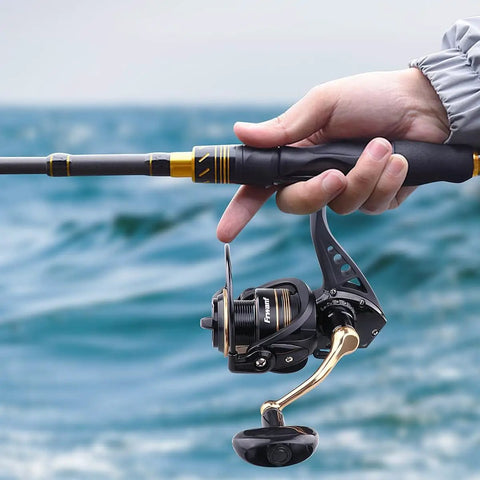 Close-up of All Around Spinning Reel For Freshwater And Saltwater Fishing, featuring a strong metal spool and tough handle in use