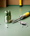 Precision tool set on workbench with screwdriver, screws, and component fittings visible