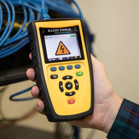 Tech pro holding Klein Tools device showing voltage screen for Get Fast Easy Test And Map Up To Eight Network Locations In One Step